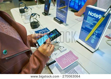 MOSCOS, RUSSIA - SEPTEMBER 20, 2018: woman hold smartphone at Samsung store in Moscow.