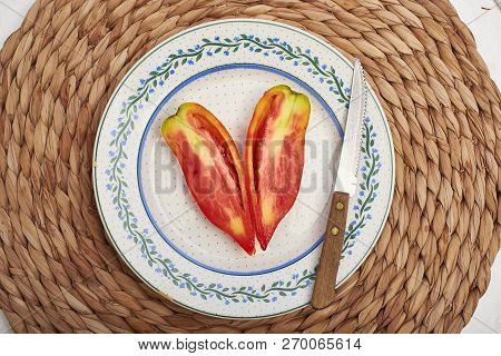Ripe Pebrot Tomato Over A Vintage Plate.