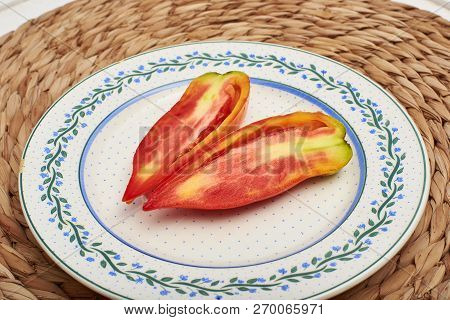 Ripe Pebrot Tomato Over A Vintage Plate.