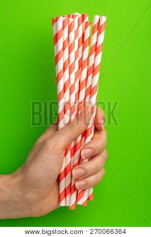 Woman Is Holding Red And White Paper Straws In Hand
