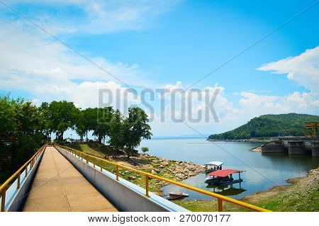 Landscape Bridge Of Reservoir River On Blue Sky And Mountain Background / Bright Day On Hydroelectri