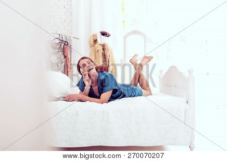 Contented Ginger Transgender Openly Laughing With His Interlocutor