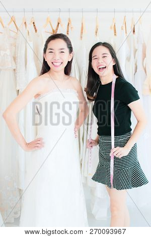 Portrait Of Bride Customer And Wedding Stylist Are Lauching At The Camera.  Asian Look Women On The 