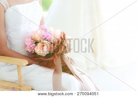 Crop Body, Close Up Of Bride Holding Beautiful Bouquet Sitting On Wood Chair, Soft Blur Background O