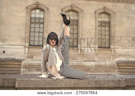 Happy Girl Do Leg Split Stretching Exercise On Stone Fence On House Facade. Yoga, Pilates, Fitness, 