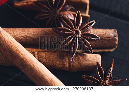 Anise Star Spices And Cinnamon Sticks On Dark Rystic Wooden Background