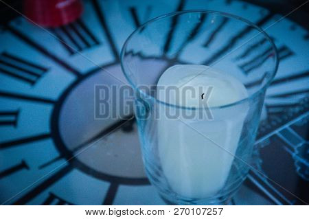 Clock Table With Turned Off White Candle And Glass Cup, Elapsed Time Symbol.