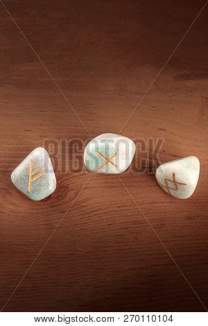 A Closeup Overhead Photo Of Norse Runes From The Futhark Alphabet, Stones With Symbols Used In Wicca