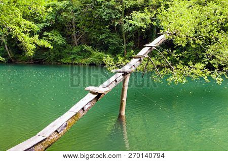 Improvised Springboard Over The Krka River (slovenia). The Krka River Shot From The Bank. It Is The 