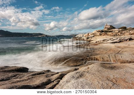 Long Exposure Image Of Waves Washing Onto Rocks On The Coast By The Genoese Tower At Punta Caldanu N