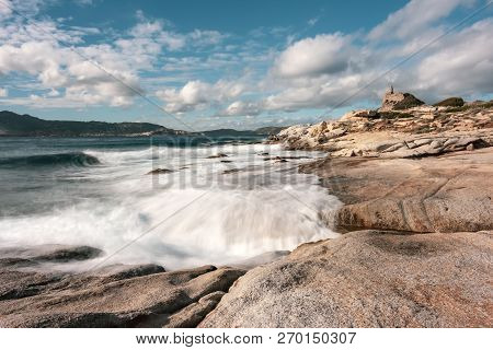 Long Exposure Image Of Waves Washing Onto Rocks On The Coast By The Genoese Tower At Punta Caldanu N