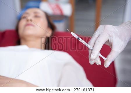 Gloved Hand Of Beautician Holding Syringe With Hylaruonic Acid