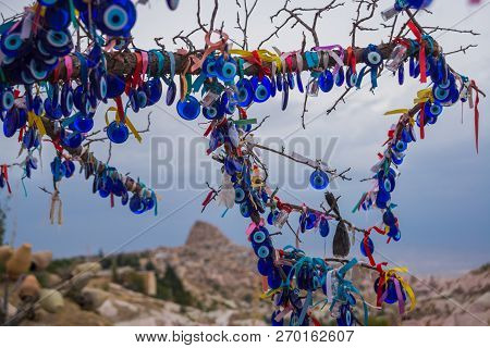 Evil Eye In Tree Behind Uchisar Castle In Cappadocia, Uchisar, Turkey.