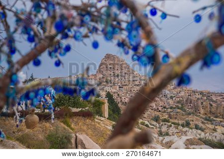 Evil Eye In Tree Behind Uchisar Castle In Cappadocia, Uchisar, Turkey.