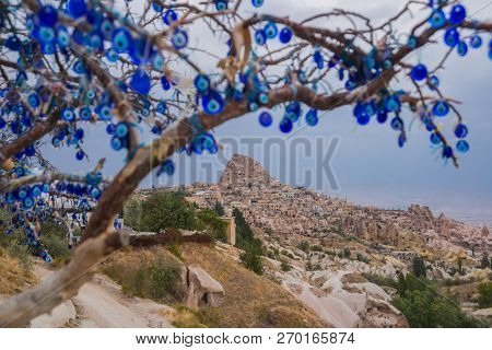 Evil Eye In Tree Behind Uchisar Castle In Cappadocia, Uchisar, Turkey.