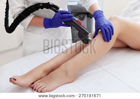 Hair Removal Cosmetology Procedure From A Therapist At Cosmetic Beauty Spa Clinic. Laser Epilation A