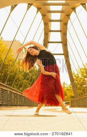 Young Slim Woman With Long Brown Hair Dancing