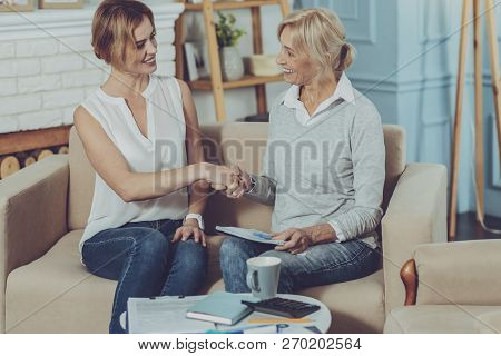 Elderly Lady Saying Goodbye To Pleasant Social Worker