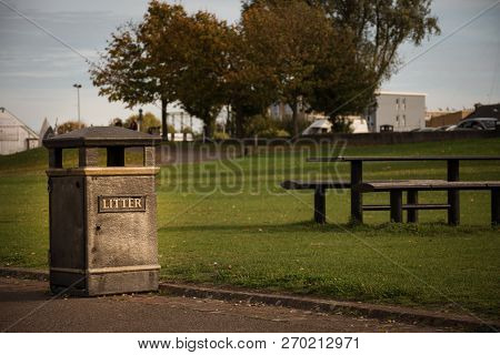 Clean Litter Bin In A Park - London, England. Garbage Bin Near Table And Benches Outdoor.