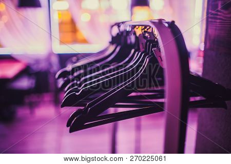 Stock Of Empty Clothes Hanger In Wardrobe, Wooden Coat Hangers Hanging On A Cloth Rail Rack In Close