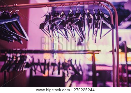 Stock Of Empty Clothes Hanger In Wardrobe, Wooden Coat Hangers Hanging On A Cloth Rail Rack In Close