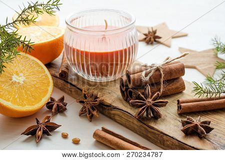 Oranges With Anisestars, Cinnamon Sticks, Juniper Branch And Candle