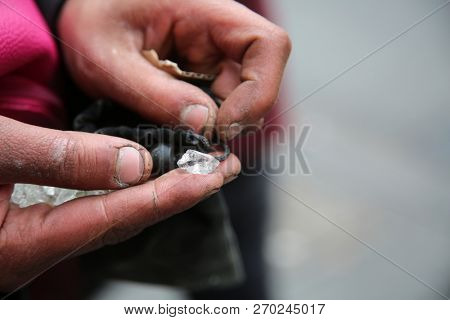 broken glass. an undeniable person tries to sell broken glass as Diamonds at $90.00 per carat to anyone they can in downtown Los Angeles California.  