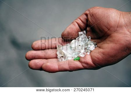 broken glass. an undeniable person tries to sell broken glass as Diamonds at $90.00 per carat to anyone they can in downtown Los Angeles California.  