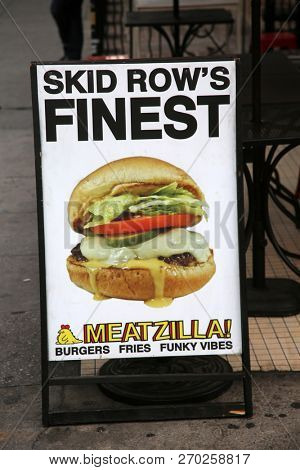 Los Angeles California, 11/19/2018: Sidewalk advertising sign for SKID ROW'S FINEST - MEATZILLZA! on the sidewalk of Downtown Los Angeles California on Skid Row. Editorial Use only.