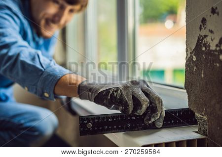 Man In A Blue Shirt Does Window Installation