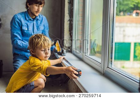 Father And Son Repair Windows Together. Repair The House Yourself