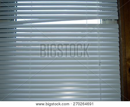 Small Opening On Closed White Window Blinds Treatment
