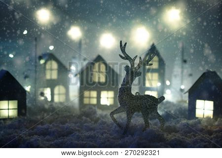 Magical Christmas Paper Village . Winter Background Landscape With Houses, Trees, Deer On Frosty Blu
