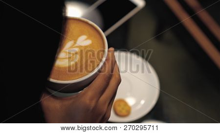 Closeup Latte Art On Top In Coffee Cups From Woman Hand Holding At The Coffee Shop Or Book Store Whi