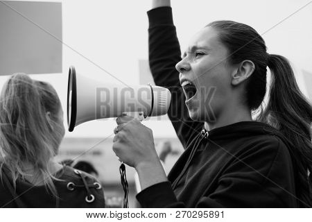 Female activist shouting on a megaphone