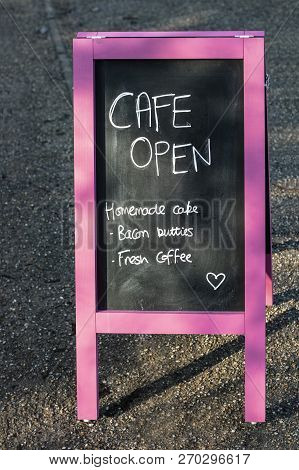 Cafe Open Sign On A Blackboard Easel, Homemade Cake, Bacon Butties, Fresh Coffee