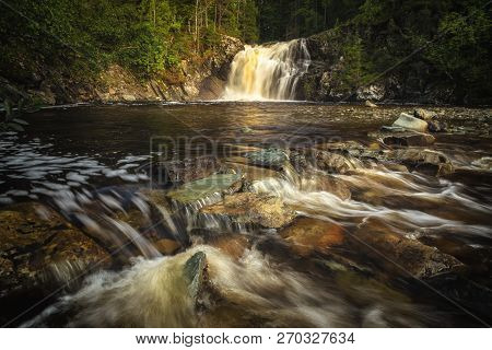 Long Exposure Shot Of Flowing River Homla And Waterfalls.