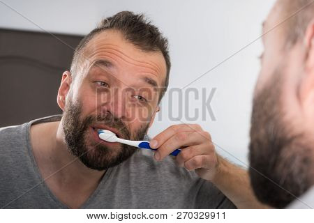 Funnny Guy Taking Care Of His Oral Hygiene, Brushing Teeth During Morning Bathroom Routine.