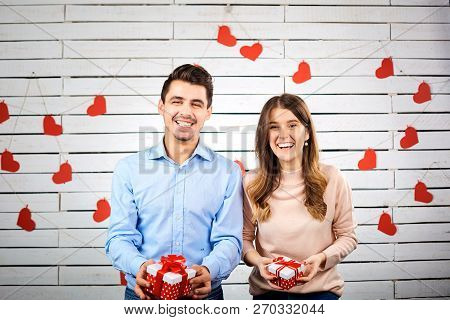 Young Happy Couple With Heart In Hands Onbackground