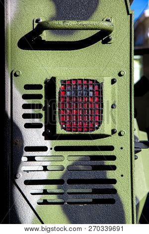The Rear Brake Signal Of An Armored Military Vehicle, The Protective Grille And Camouflage Bark Of T