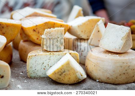 Hard Varieties Of Goat Cheese With Spices Close-up On The Table.