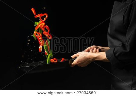 Cooking Fresh Vegetables In The Pan Chef. Horizontal Photo Viewing. Dark Black Background