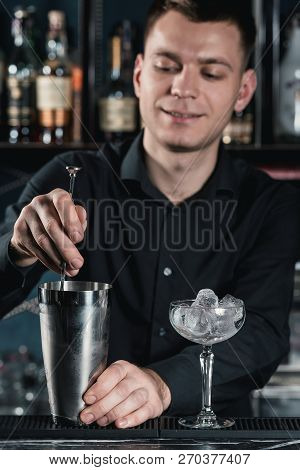 Bartender Making Boulevardier Cocktail Pouring Fluid Into Glass. Bar On A Background