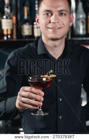 Boulevardier Cocktail In Hands Of A Bartender. Bar On A Background