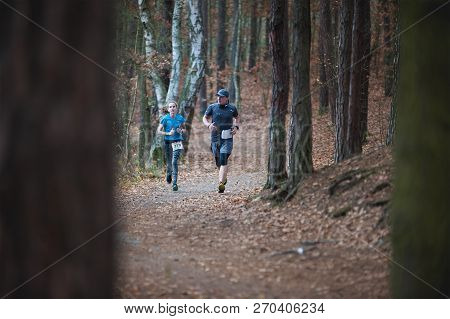 Czech Republic, Pilsen, November 2018: Hannah Pilsen Trail Krkavec. Runners Man And Woman Running Ab