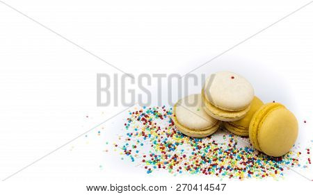 Macaroons Close - Up With Culinary Decor Isolated On A Light Background.