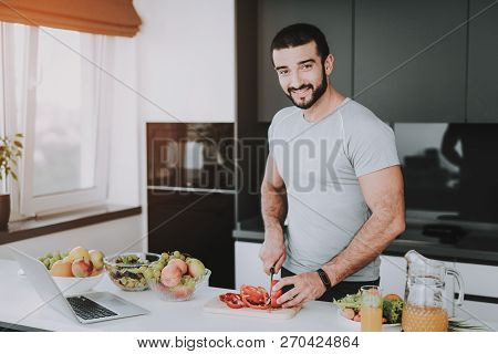Athletic Girl Stands In Kitchen. Cooking Concept.. Healthy Lifestyle. Young And Handsome. Sport Body