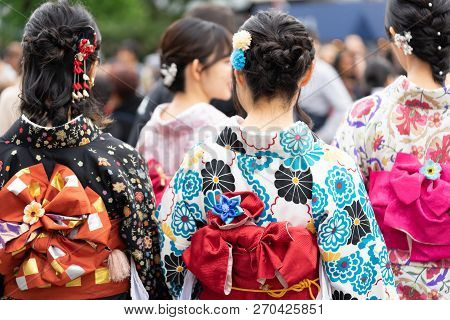Young Girl Wearing Japanese Kimono Standing In Front Of Sensoji Temple In Tokyo, Japan. Kimono Is A