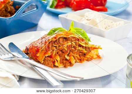Tasty Lasagne With Meat Covered With Cheese Served On White Plate