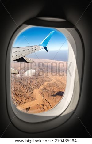Aerial View Of The Sahara Desert And Red Sea And The Wing Of A Commercial Airplane Photographed Thro